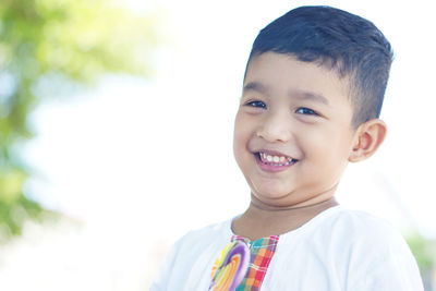 Portrait of cute boy smiling outdoors