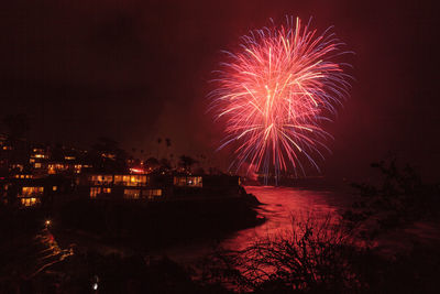 Firework display in city at night