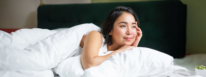 Young woman sleeping on bed at home