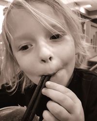 Close-up portrait of cute girl playing