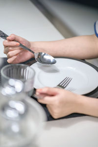 Close-up of woman hand on table