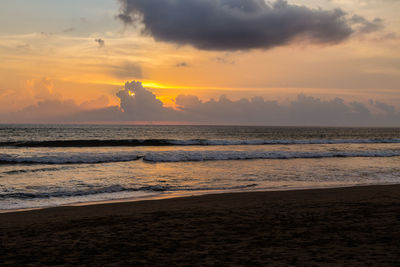 Scenic view of beach against sky during sunset