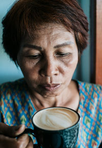 Close-up portrait of young woman drinking drink