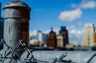 Close-up of chainlink fence against blue sky