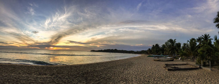 Panoramic view of beach against sky during sunset