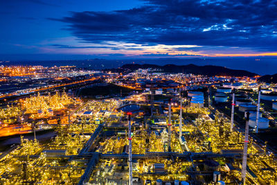 High angle view of illuminated cityscape against sky at night