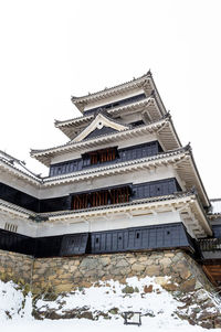 Low angle view of building against sky during winter