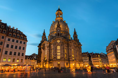 Low angle view of illuminated cathedral against sky at dusk