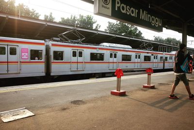 Woman standing at railroad station