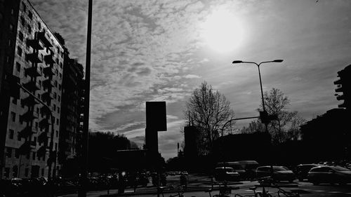 Silhouette of buildings against cloudy sky