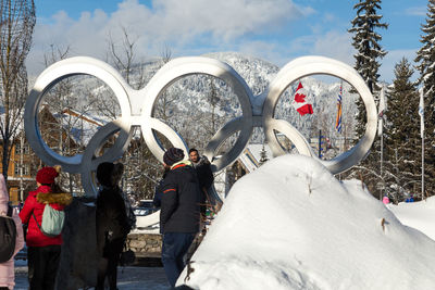 Rear view of people walking on snowcapped mountain