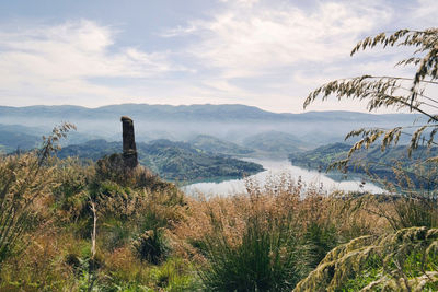 Scenic view of landscape against cloudy sky