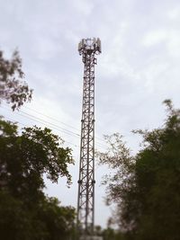 Low angle view of communications tower against sky