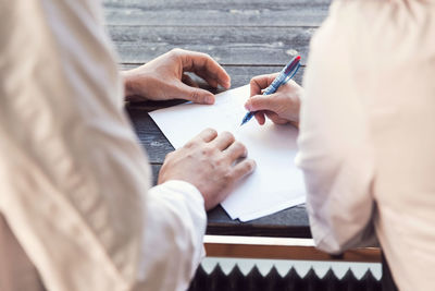 High angle view of owners doing paperwork in grocery store