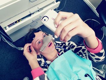 High angle view of young woman in dentist chair