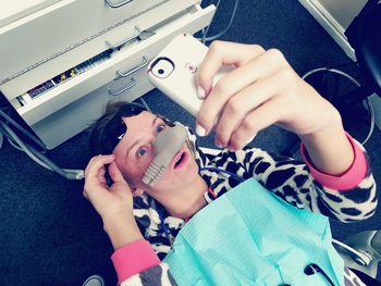 High angle view of young woman in dentist chair