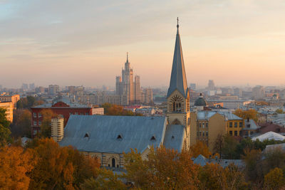 Cityscape from moscow, russia. church on foreground and one of seven sisters houses on background.