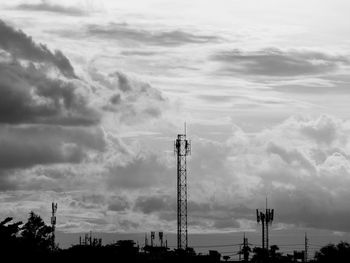 Low angle view of communications tower against sky