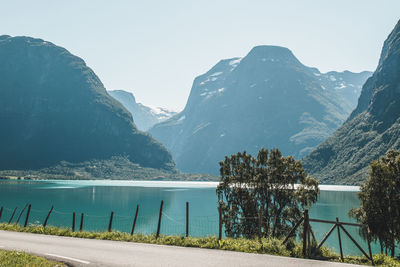 Scenic view of lake and mountains against clear sky