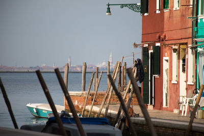 Ship in city against clear sky