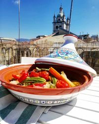 Close-up of salad in bowl against building