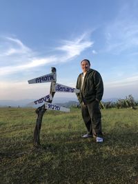 Full length of man standing on field against sky