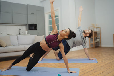 Full length of woman exercising in gym