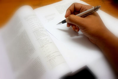 Close-up of hand holding book