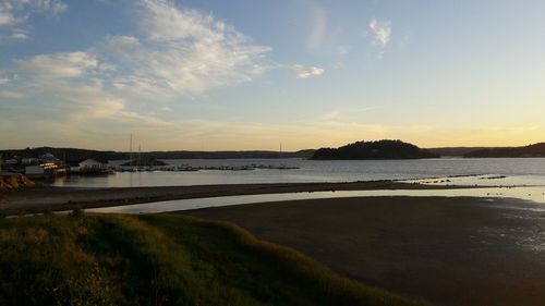 Scenic view of river against sky during sunset