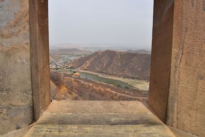 Road leading towards mountains against sky