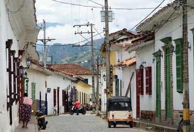 People on street amidst buildings in city