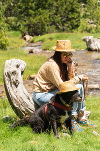 Full length of woman sitting on grass