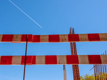 Low angle view of vapor trail against clear blue sky