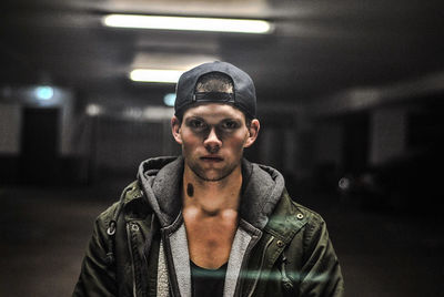 Portrait of confident young man standing in parking lot