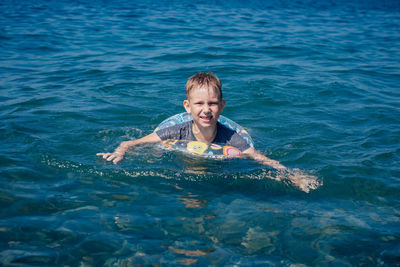 Portrait of smiling girl swimming in sea