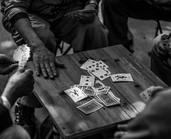 High angle view of friends playing cards at table