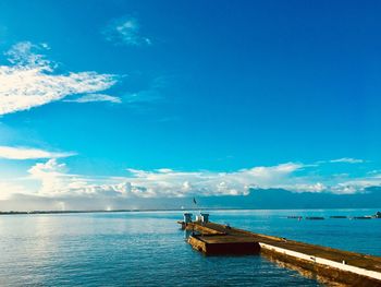 Scenic view of sea against blue sky