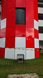 Red building seen through glass window