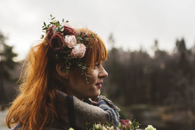 Red-haired woman with flowers in her hair