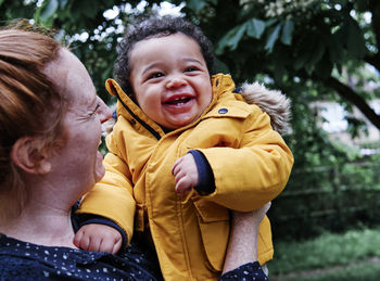 Cheerful son and mother in park