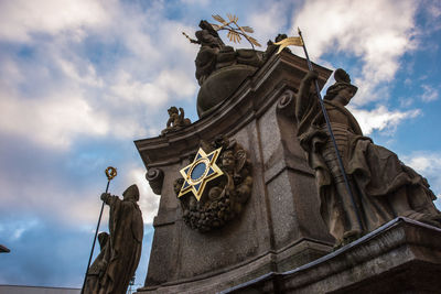 Low angle view of statues against sky