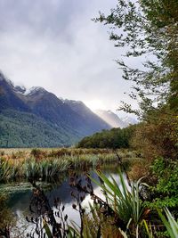 Scenic view of lake and mountains against sky