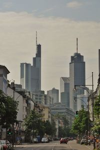 Cars on street against buildings in city