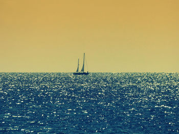 Scenic view of sea against clear sky during sunset