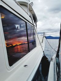 Sailboats in sea seen through window