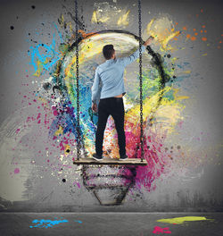Rear view of man standing against multi colored wall