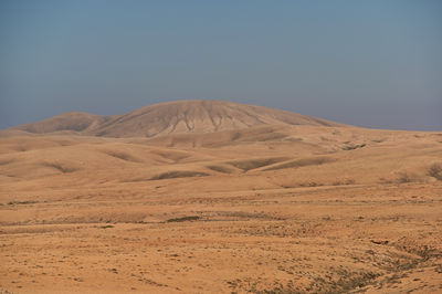 Scenic view of desert against clear sky