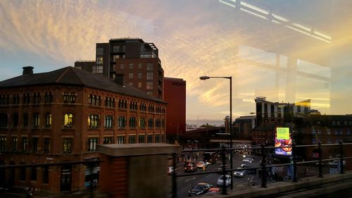 Buildings in city at sunset