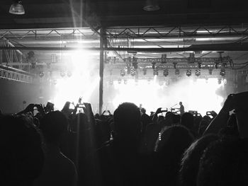 Silhouette people photographing at music concert