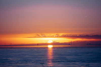 Scenic view of sea against romantic sky at sunset